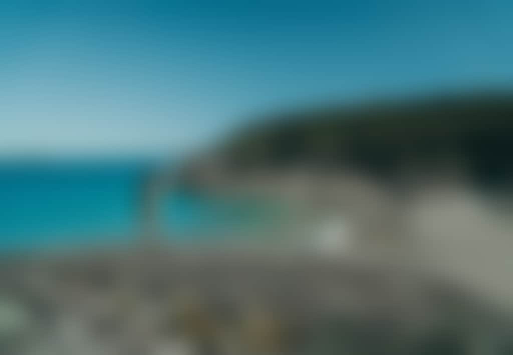 Squeaky Beach Wilsons Prom woman standing on rocks in front of turquoise water