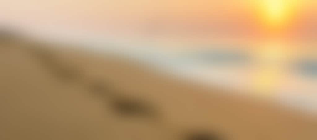 Ninety Mile Beach footsteps in the sand at sunset