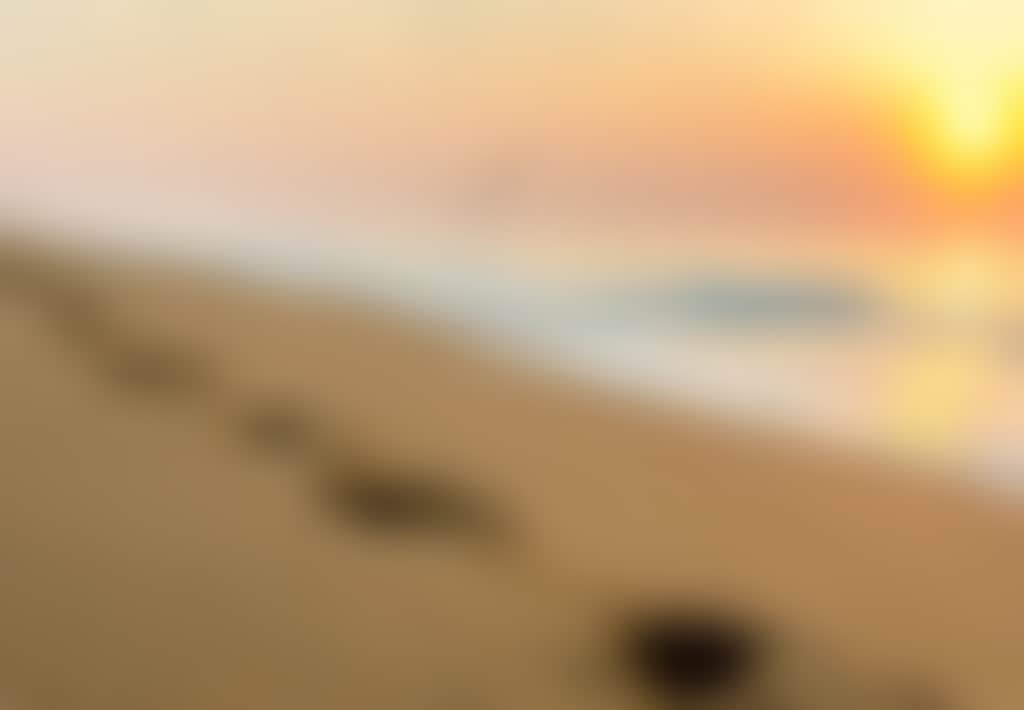 Ninety Mile Beach footsteps in the sand at sunset