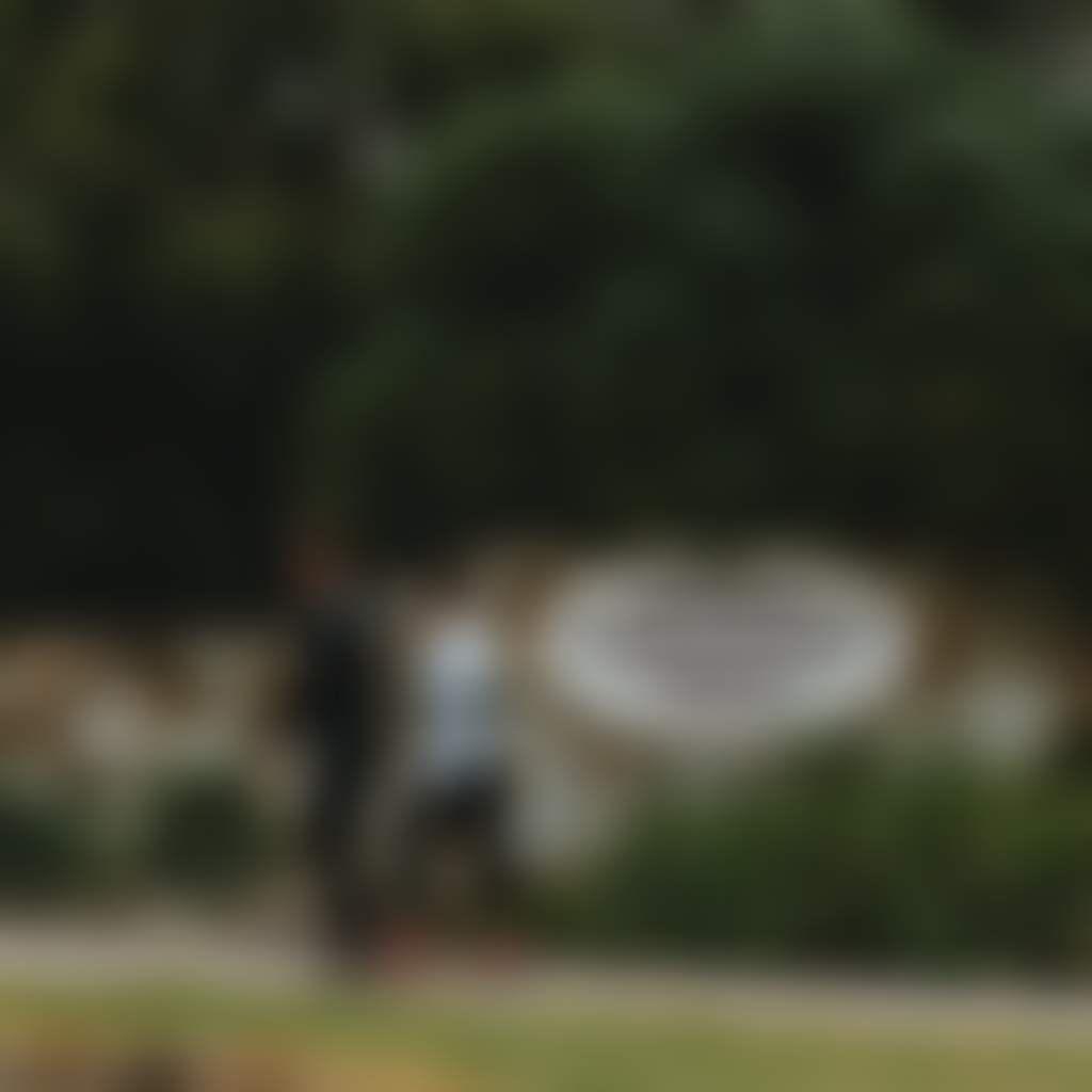 Traralgon Railway Reservoir Conservation Reserve couple walking past park entry sign