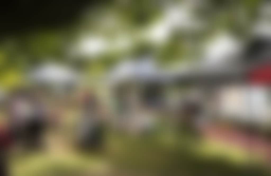 Warragul Farmers Market produce and artisan stalls with customers browsing