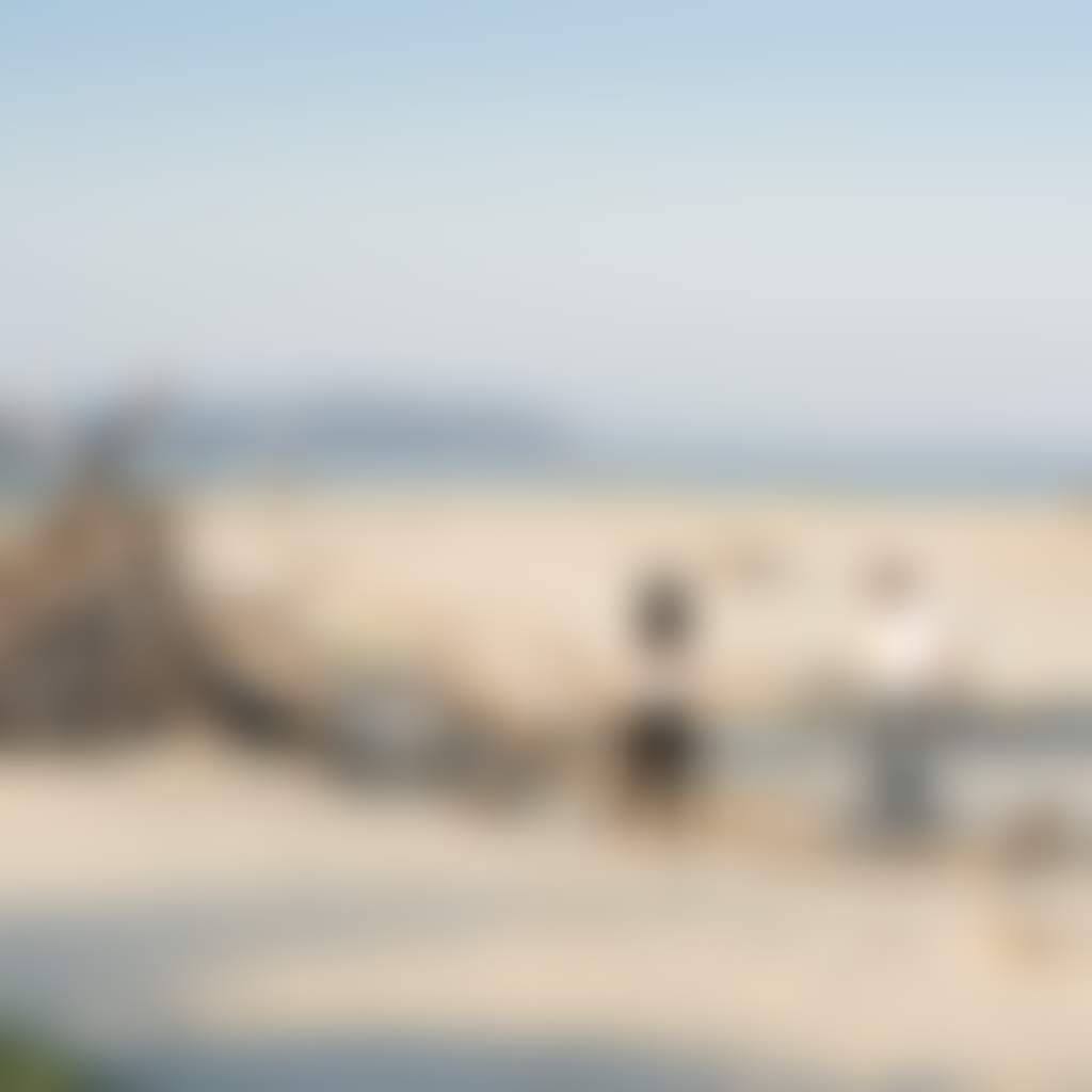 Couple admiring driftwood teepee hut on Inverloch beach