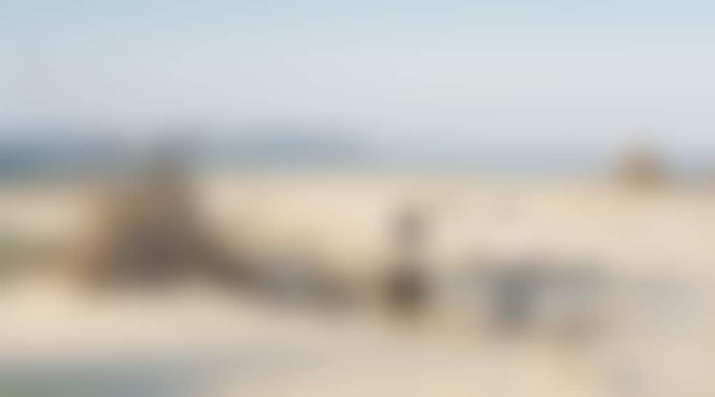Couple admiring driftwood teepee hut on Inverloch beach