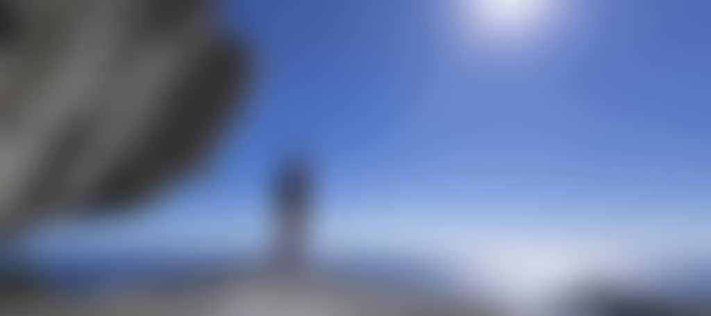 Man standing on rock overlooking water at Wilsons Promontory