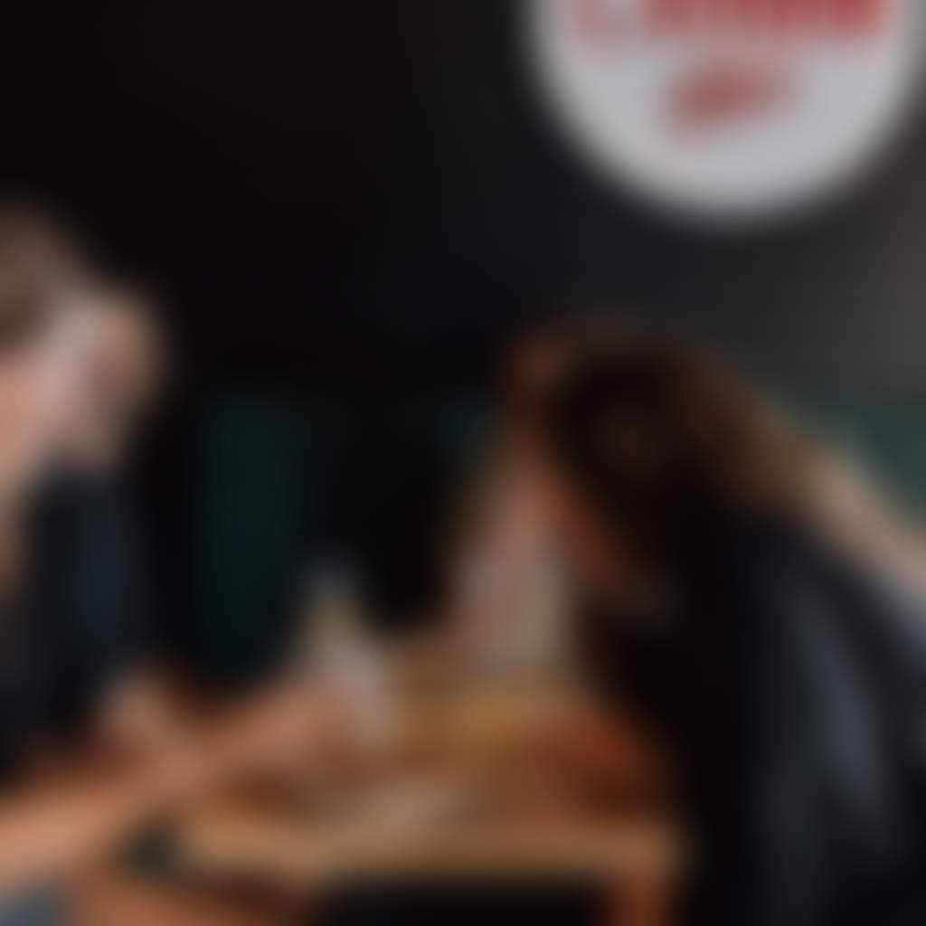 Good Land Brewing people sitting at tables laughing while drinking beer inside brewery